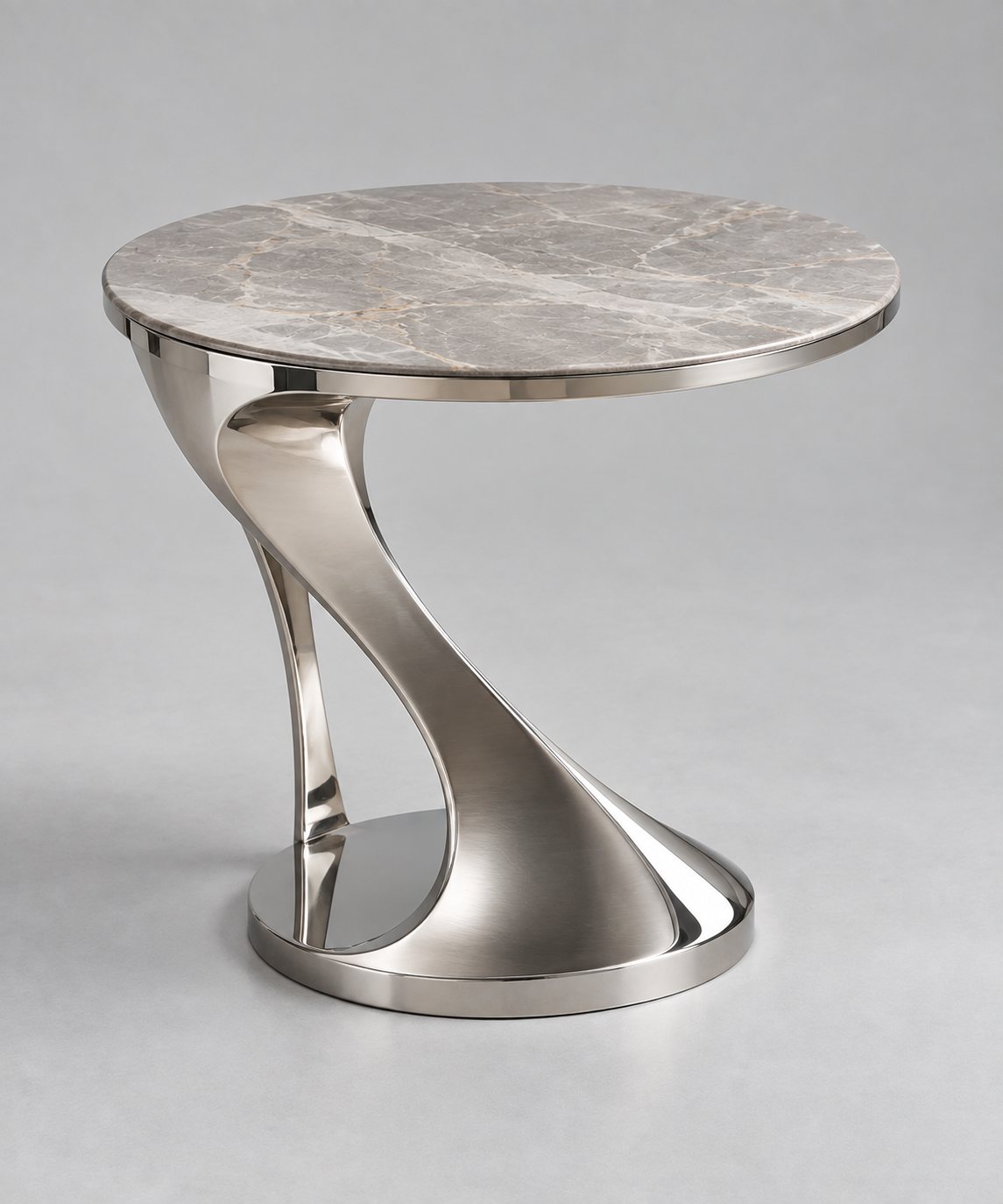 Sculpted side table with a curved polished metal base and stone top